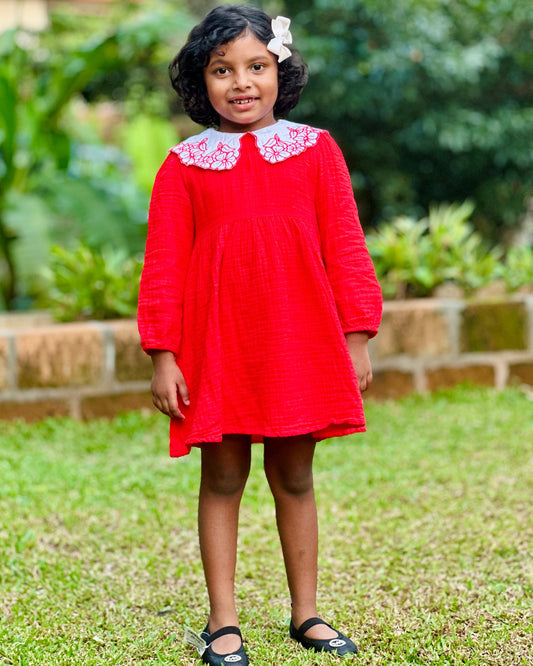 Girl in red frock ; looks cute